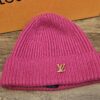 Louis Vuitton Spark Cashmere Beanie Fuchsia Pink shown front on with the gold tone LV logo on the folded cuff