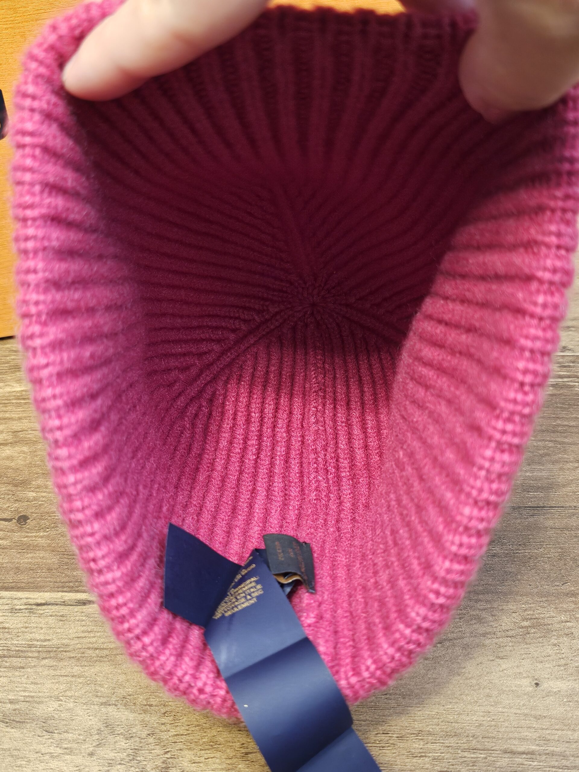 Inside of the Louis Vuitton cashmere beanie showing the ribbed crown and navy ribbon