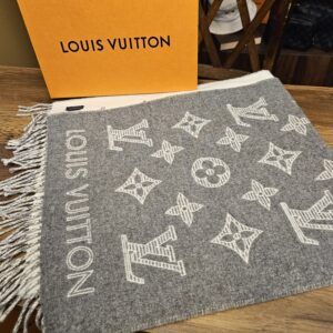 Louis Vuitton Monogram Shadow Wool Cashmere Scarf Gray Ivory folded beside the Louis Vuitton box