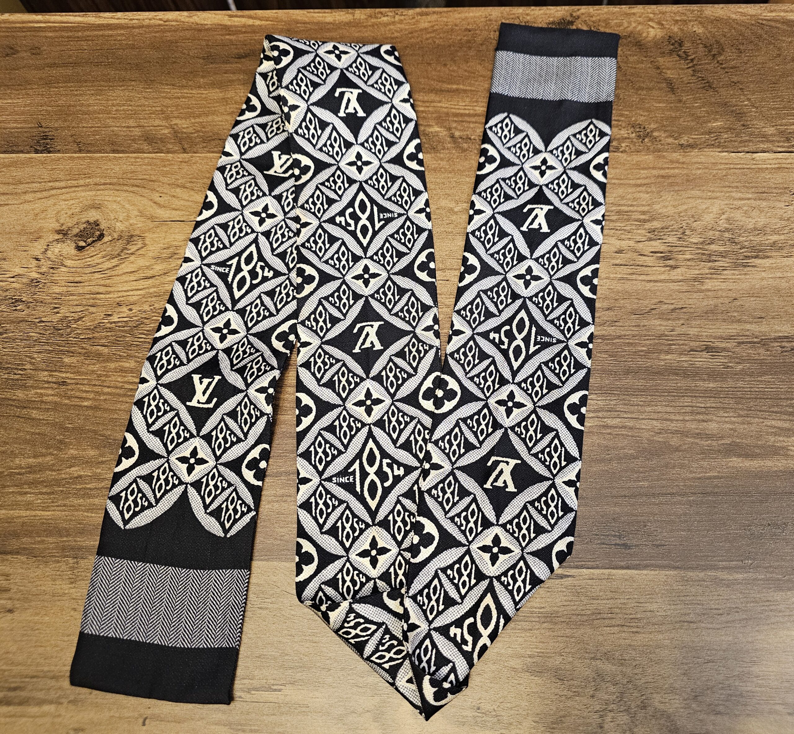 Since 1854 silk bandeau laid out to show the full black, cream and gray pattern