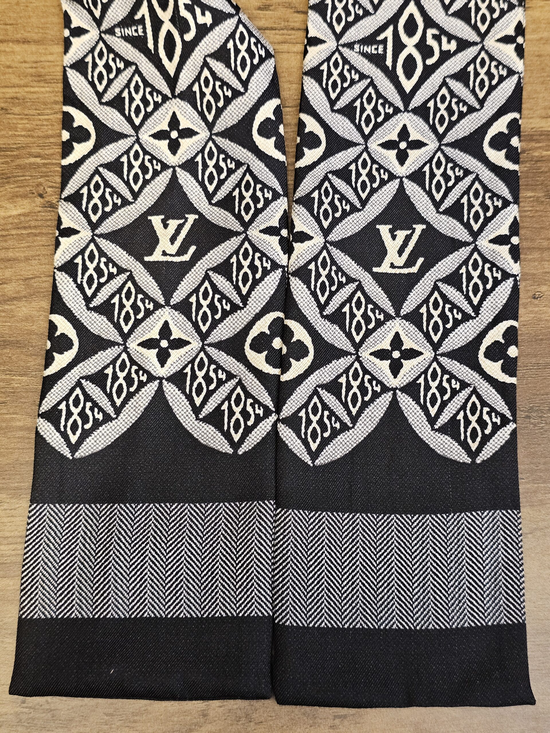 Since 1854 bandeau folded to show the pattern and the striped ends