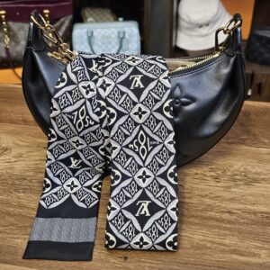 Bandeau tied around the handle of a black Louis Vuitton bag