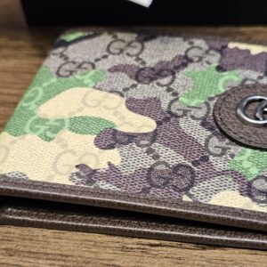 Gucci camouflage bifold wallet angled to show the GG Supreme print