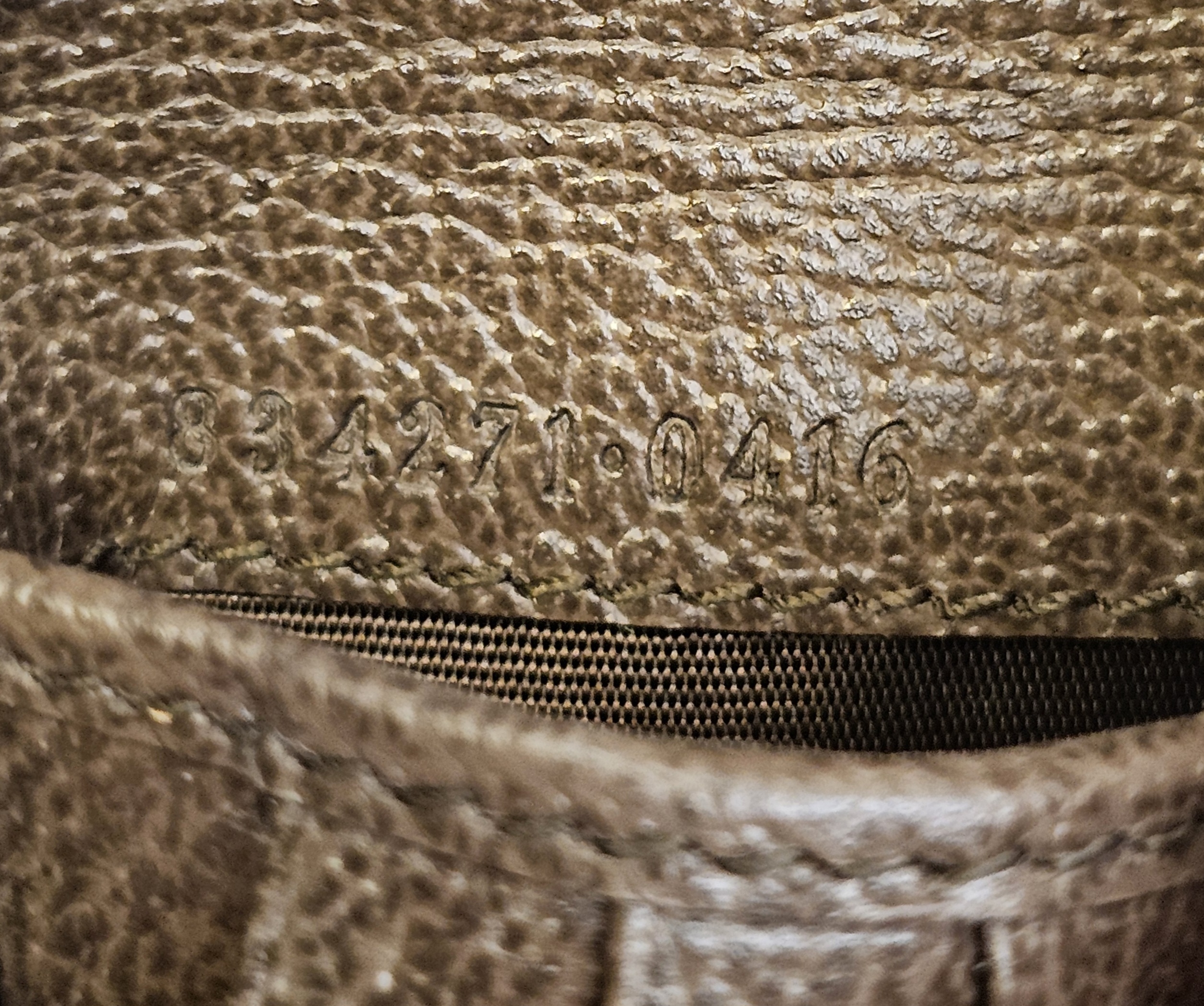 Heat stamp inside the Gucci wallet showing the serial and style number 834271 0416