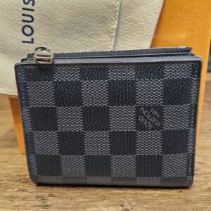 Louis Vuitton Damier Graphite Smart Wallet closed on its dust bag, showing the graphite check canvas and zip pull