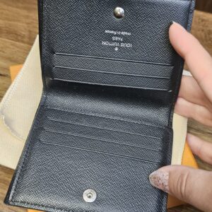 Smart Wallet opened to show the card slots, snap closure and black leather interior