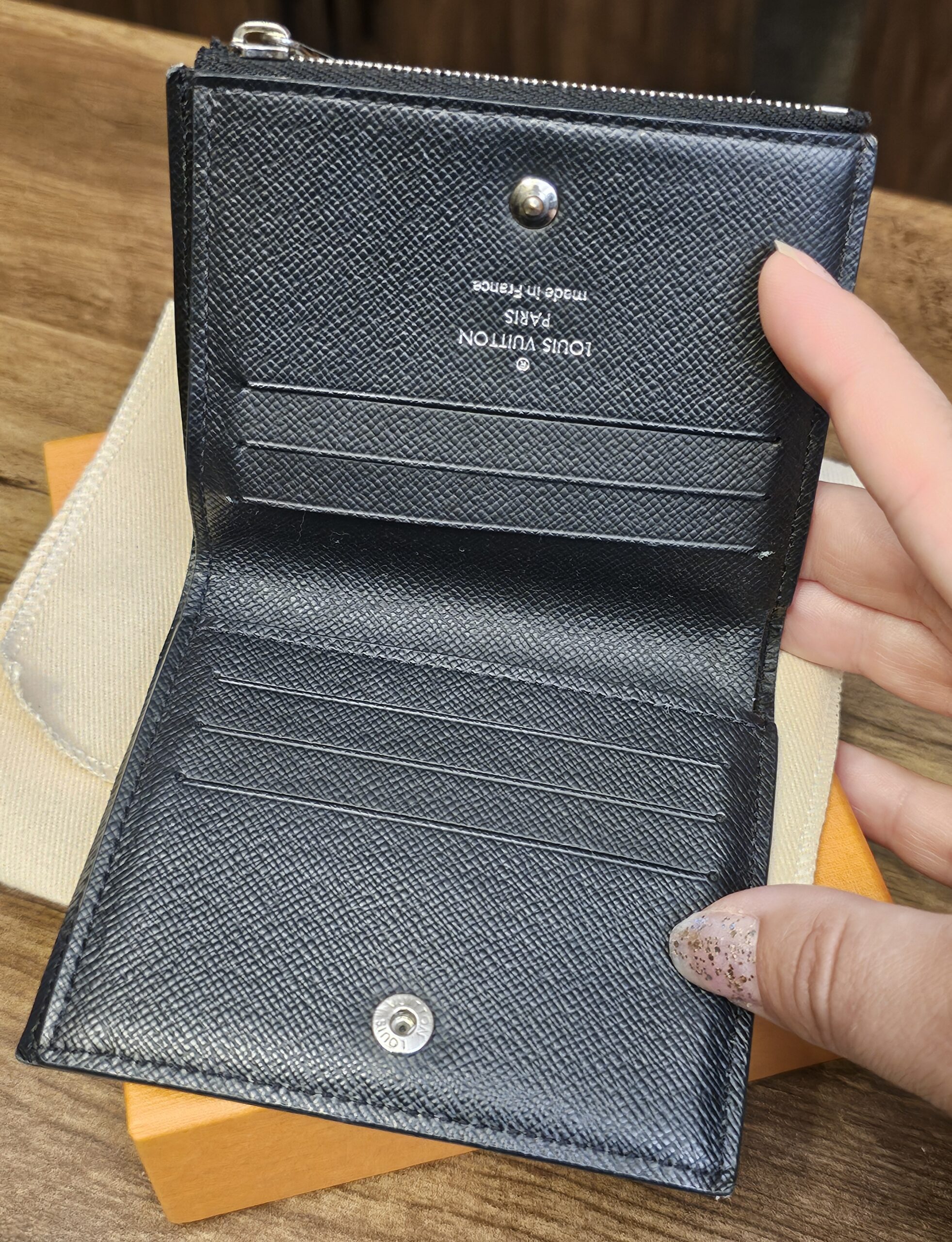 Smart Wallet opened to show the card slots, snap closure and black leather interior