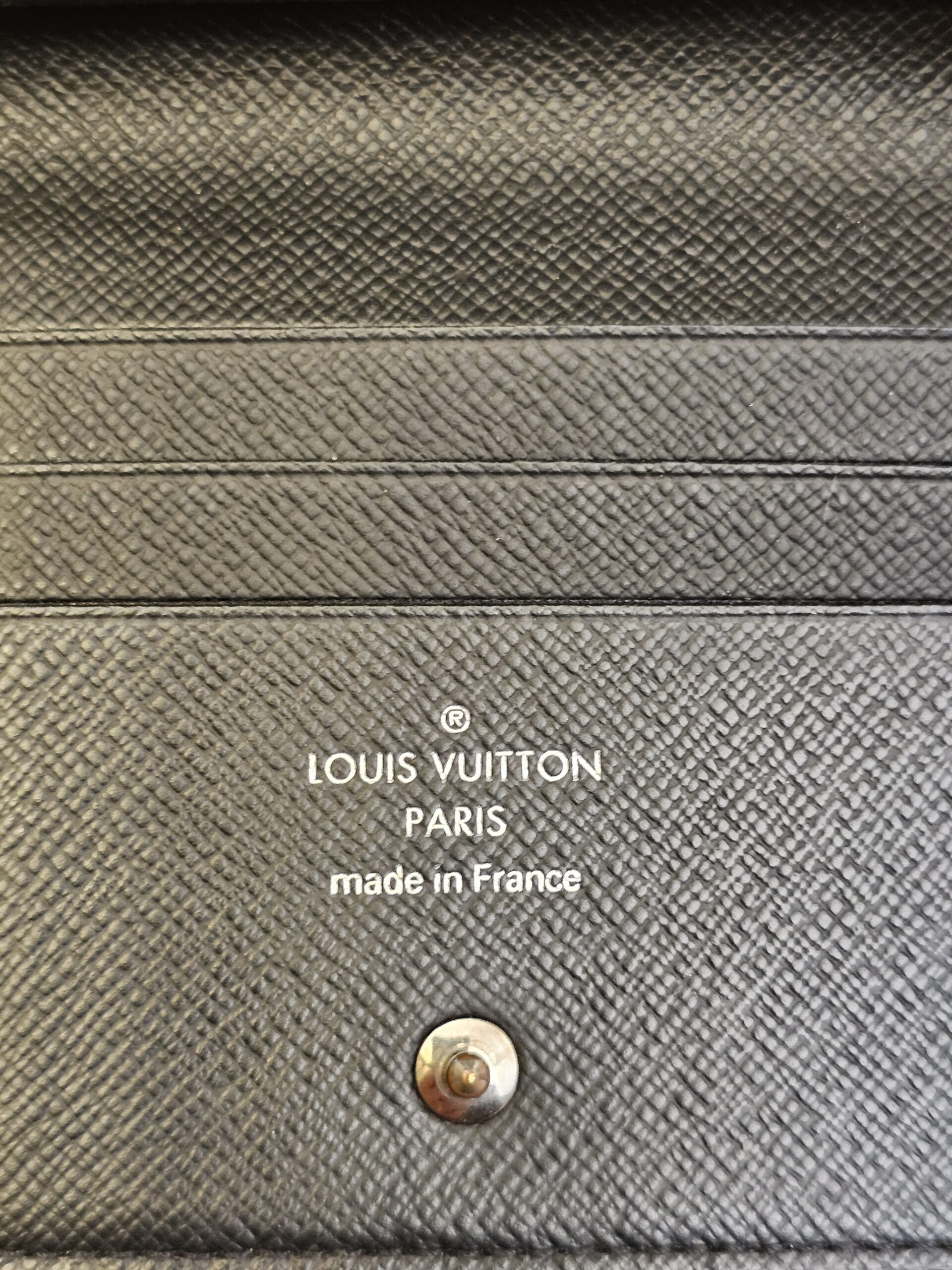 Louis Vuitton Paris made in France stamp inside the Smart Wallet beside the snap