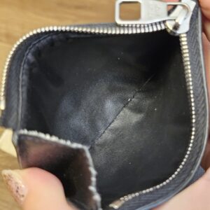 Zippered coin compartment of the Smart Wallet opened to show the leather lining