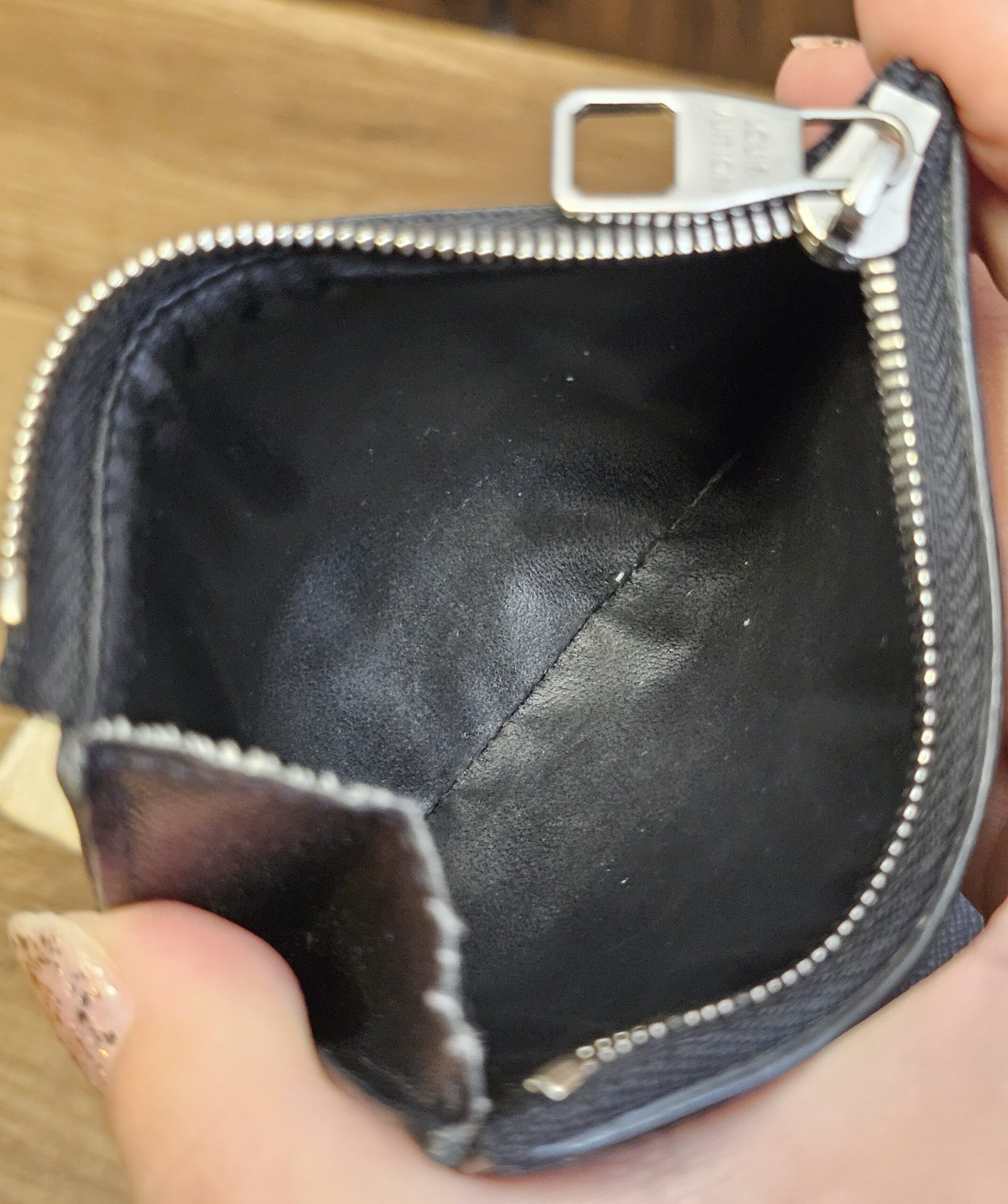 Zippered coin compartment of the Smart Wallet opened to show the leather lining
