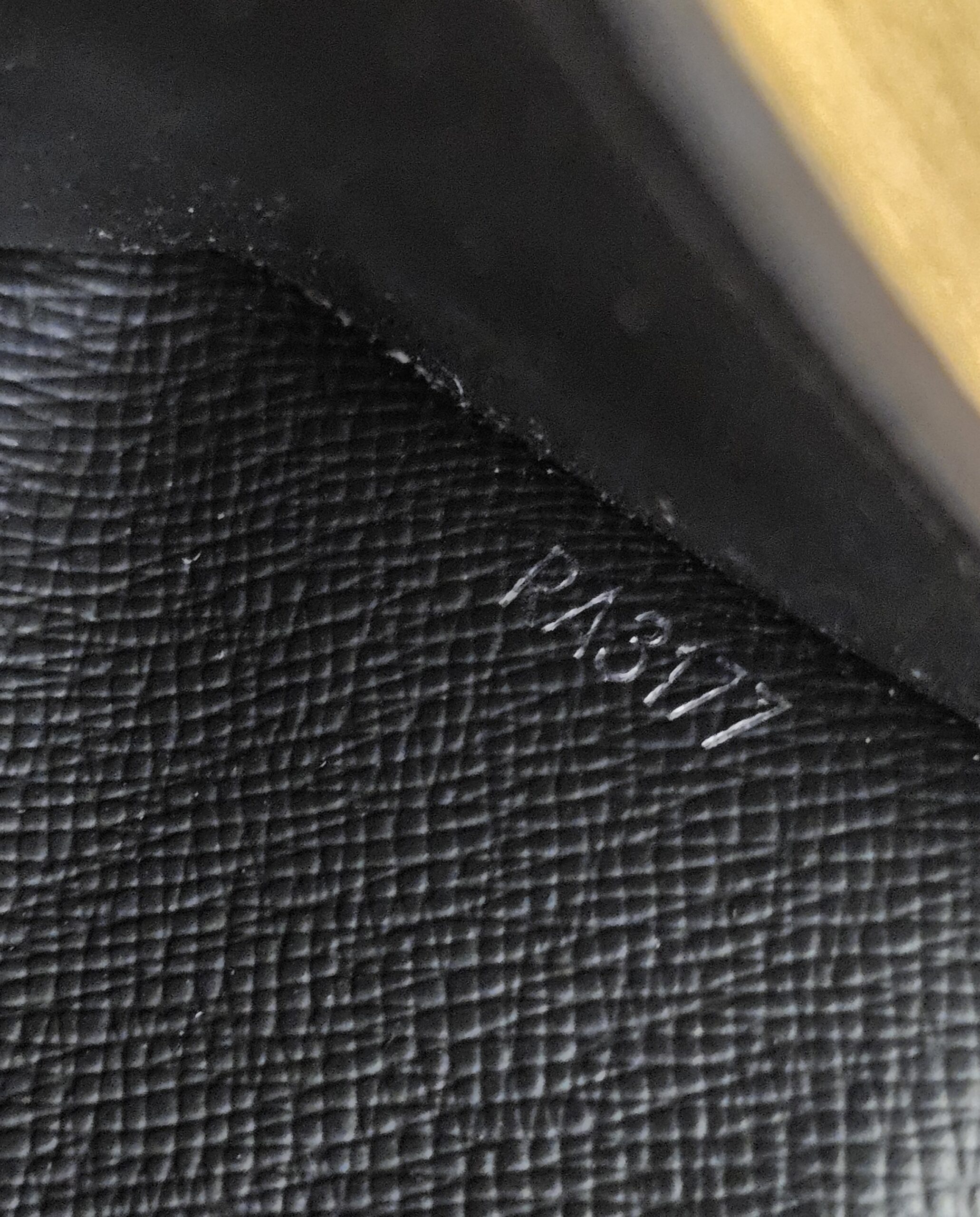 Close up of the date code RA3177 stamped inside the Smart Wallet