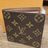 Louis Vuitton Monogram Porte Billets Cartes Credit Monnaie Wallet closed, showing the Monogram canvas exterior