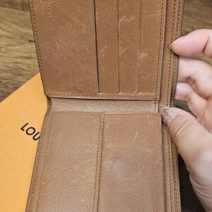 Wallet opened to show the card slots and brown leather interior
