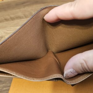Brown leather lining of the Monogram wallet held open