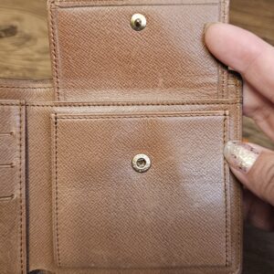Snap coin pocket on the outside of the Monogram wallet