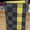 Louis Vuitton Damier Graphite Pocket Organizer Yellow Limited Edition closed, showing the yellow stripe on Damier Graphite canvas