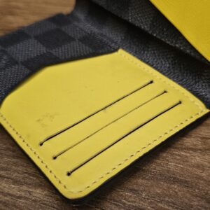 Close up of the yellow leather card slots inside the pocket organizer