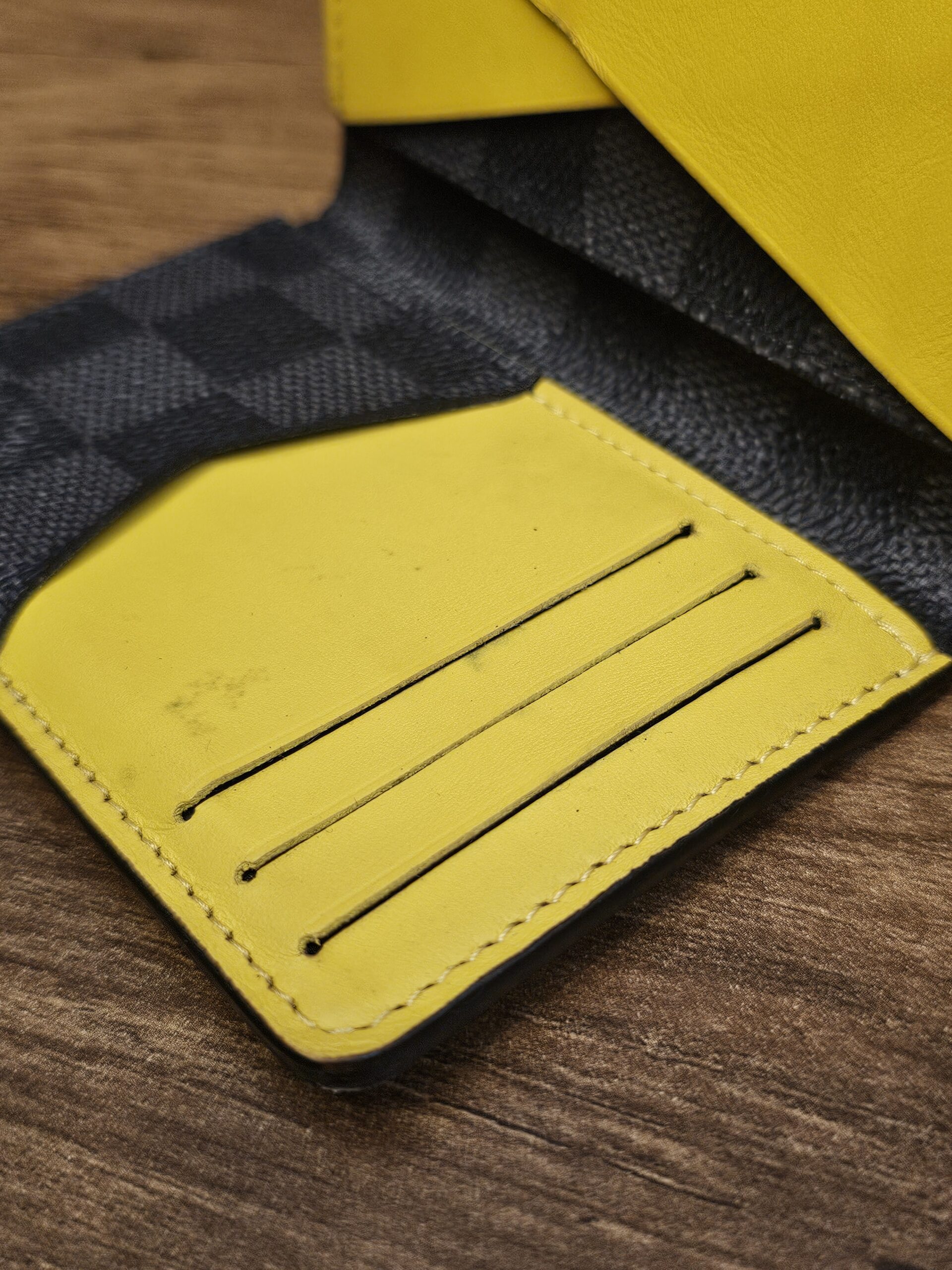 Close up of the yellow leather card slots inside the pocket organizer