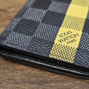 Louis Vuitton Paris stamp on the yellow stripe of the pocket organizer