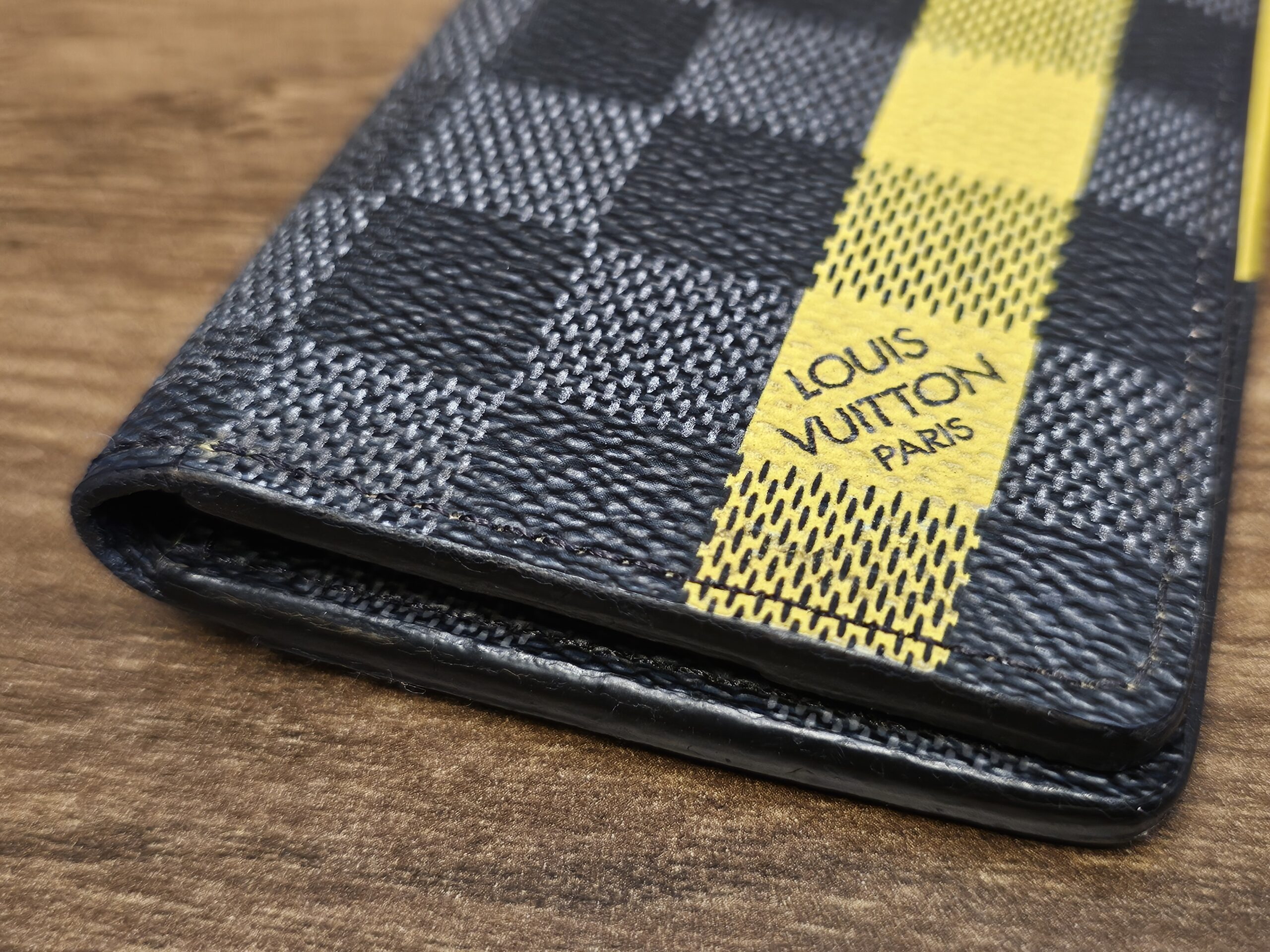 Louis Vuitton Paris stamp on the yellow stripe of the pocket organizer