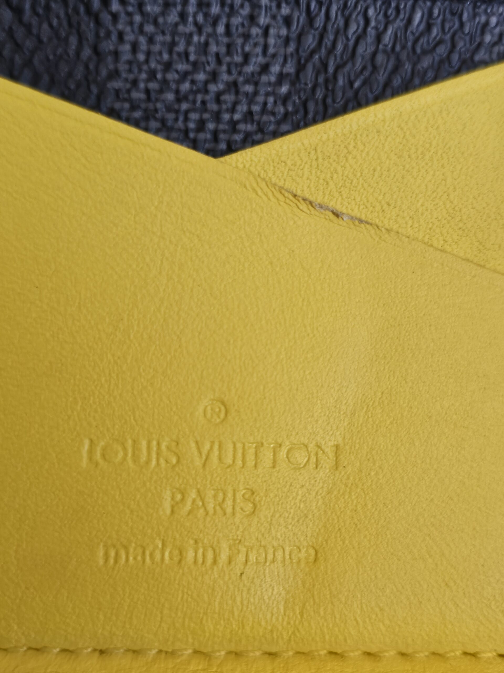 Yellow leather pocket inside the organizer with the Louis Vuitton Paris made in France stamp