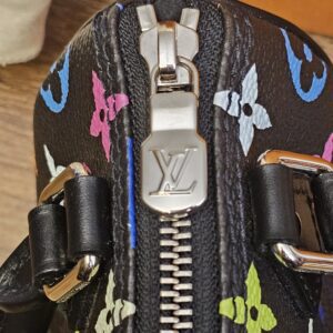 Close up of the silver-tone LV zip pull on the Nano Speedy