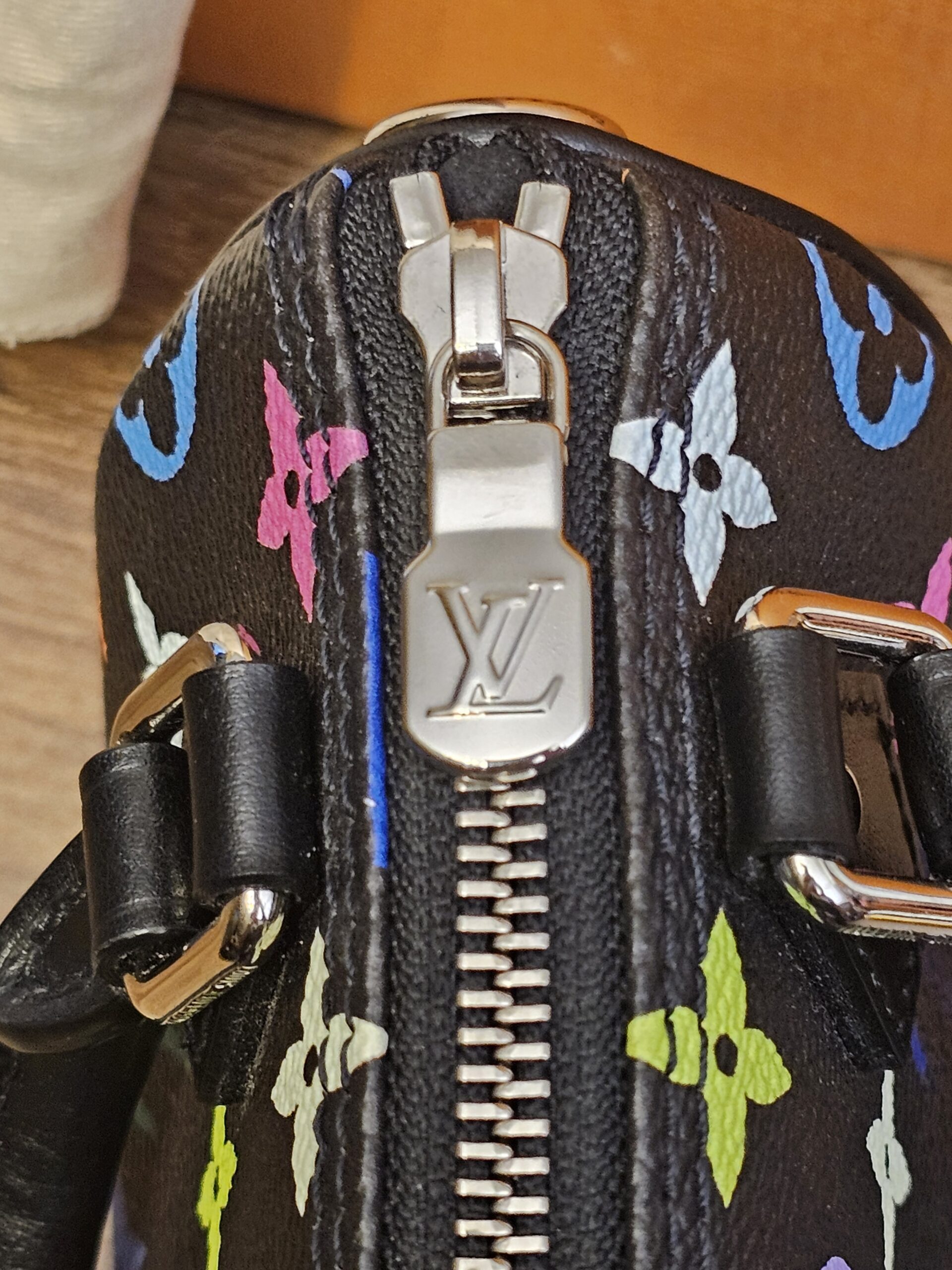 Close up of the silver-tone LV zip pull on the Nano Speedy