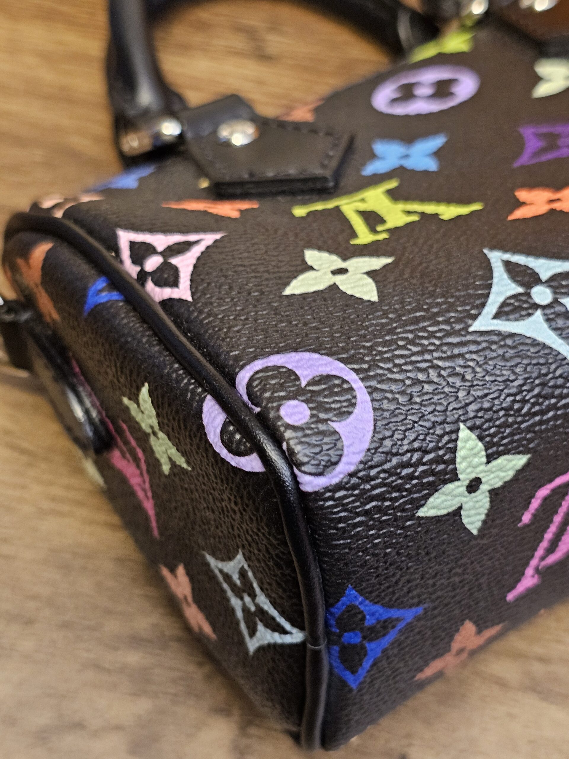 Close up of the multicolor monogram canvas at the corner