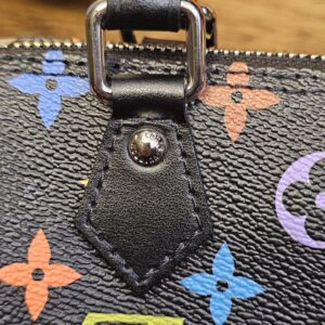 Close up of the black leather tab and rivet at the base of the handle
