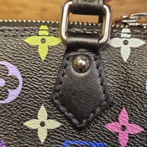 Leather handle tab and rivet on the other side of the bag