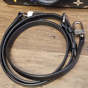 Coiled black leather strap with its silver-tone clasps