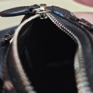 Close up of the zip and silver-tone pull