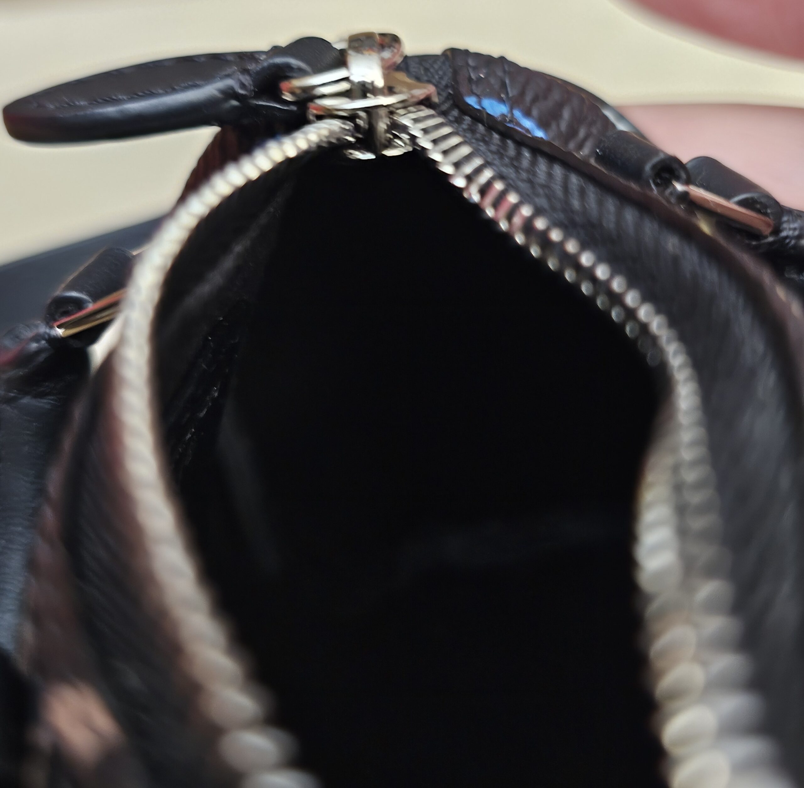 Close up of the zip and silver-tone pull