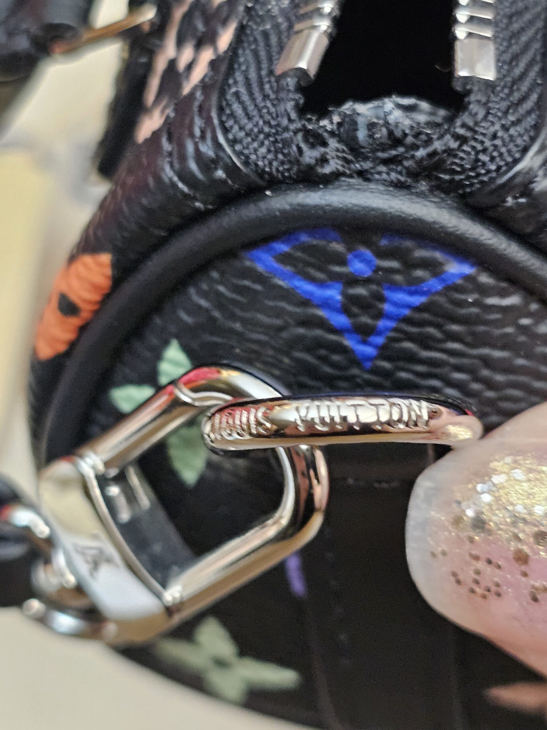 Close up of the engraved silver-tone clasp