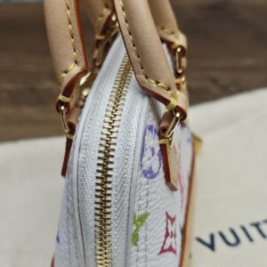 Side profile of the micro Alma showing the gold-tone zip