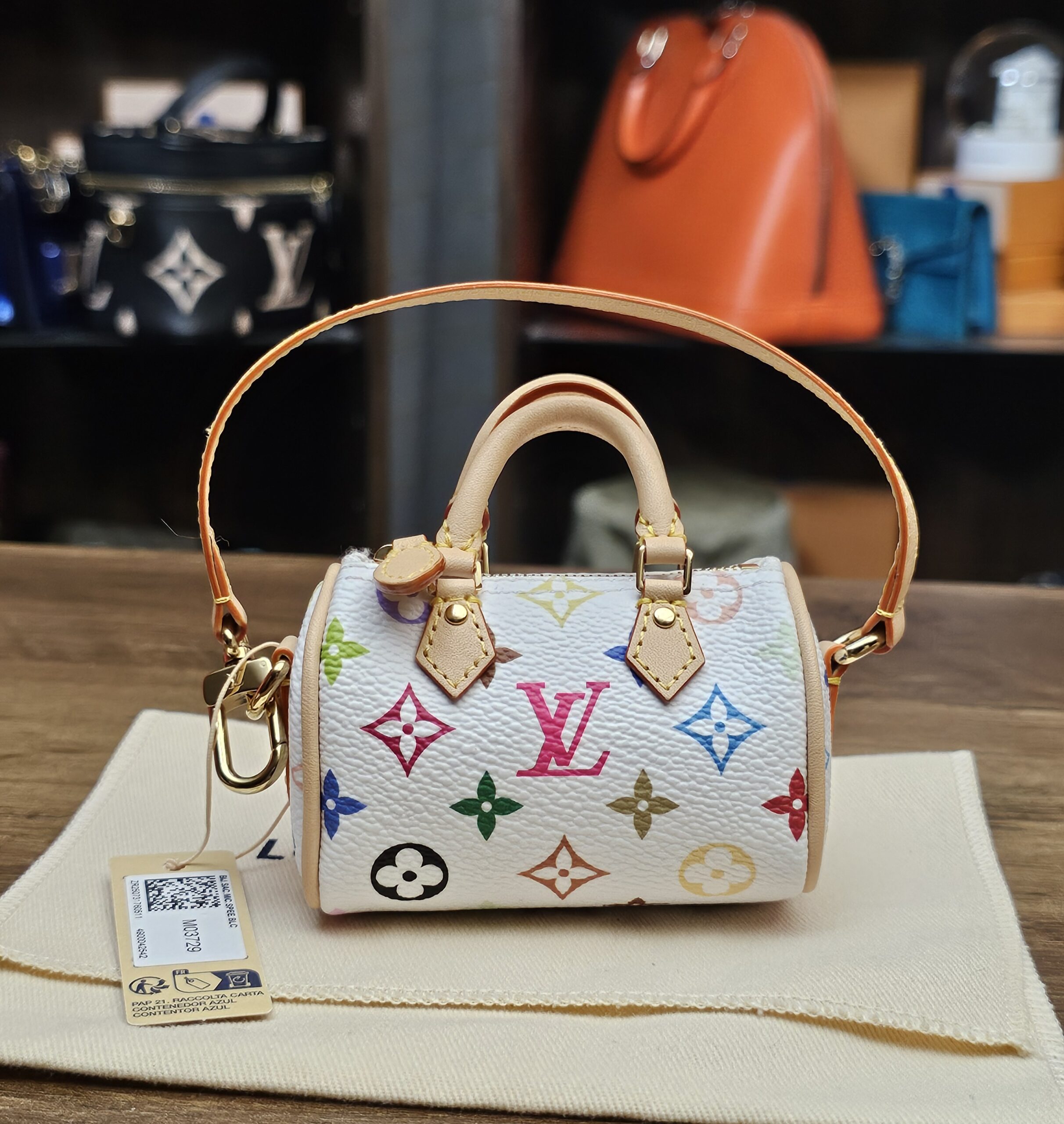Louis Vuitton x Takashi Murakami Monogram Multicolor Micro Speedy White - front view with strap, retail tag and dust bag