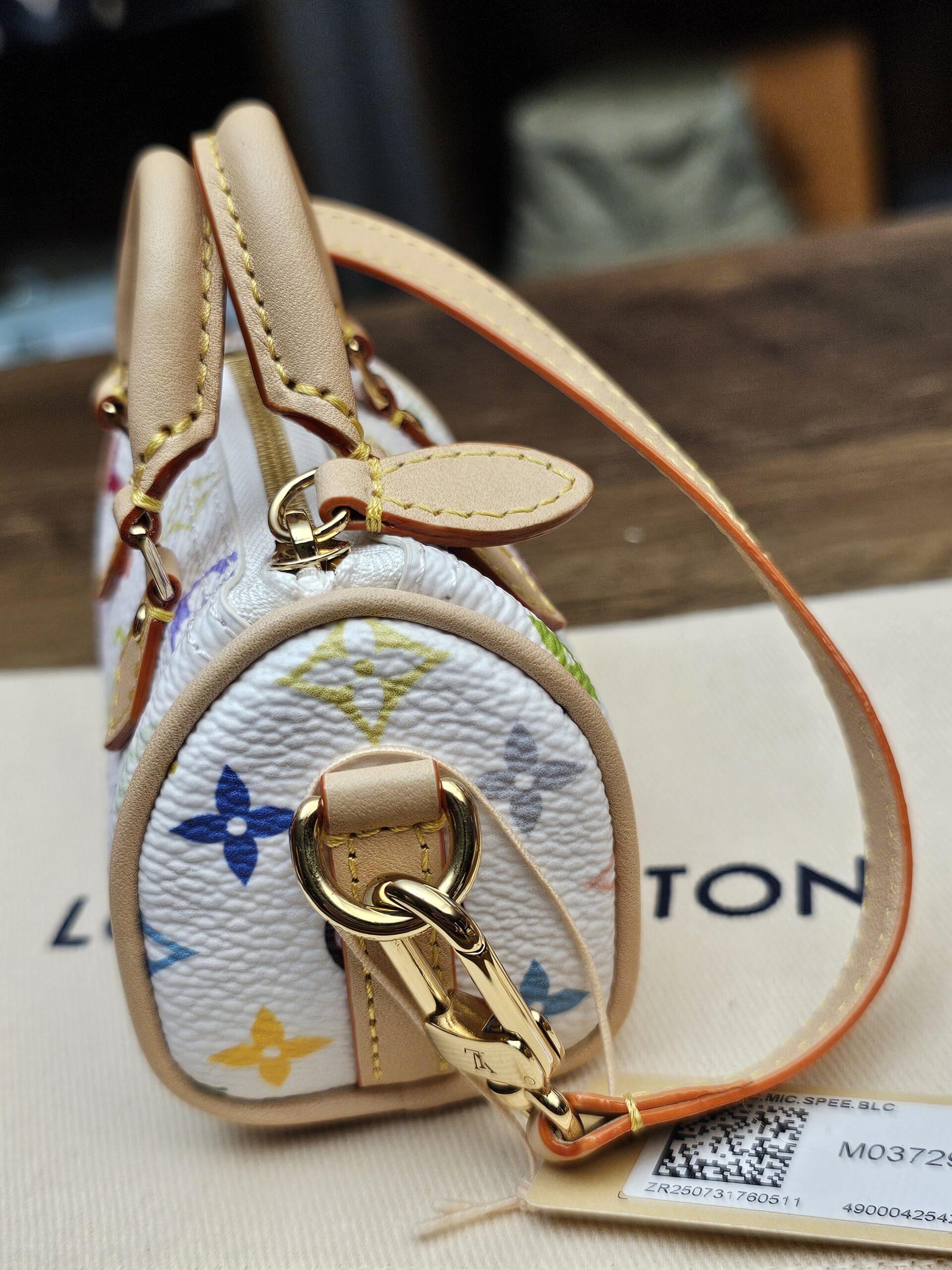 End view with the gold-tone clasp and vachetta strap