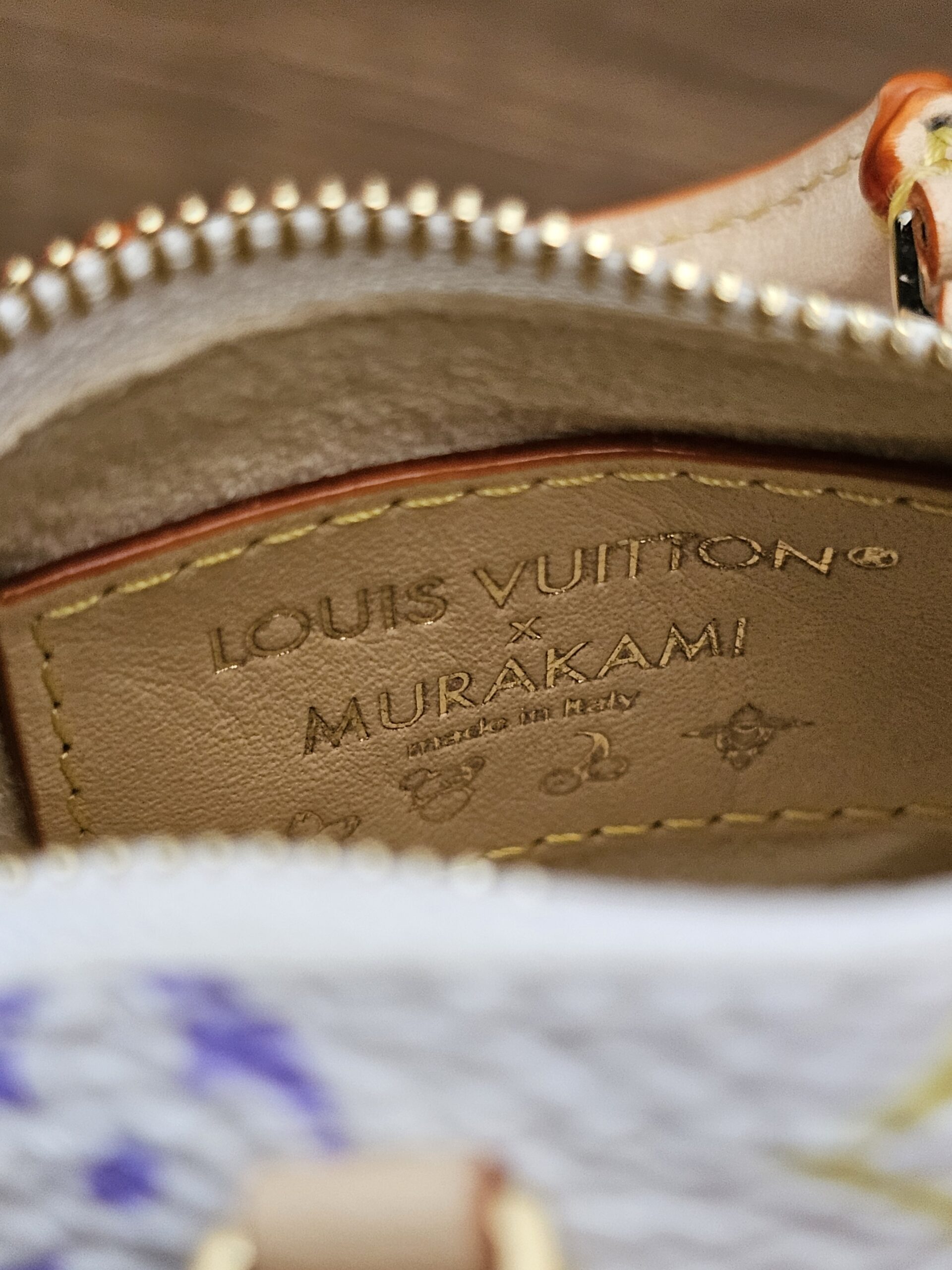 Interior leather plaque reading x Murakami made in Italy