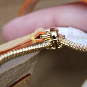 Close up of the gold-tone zip pull