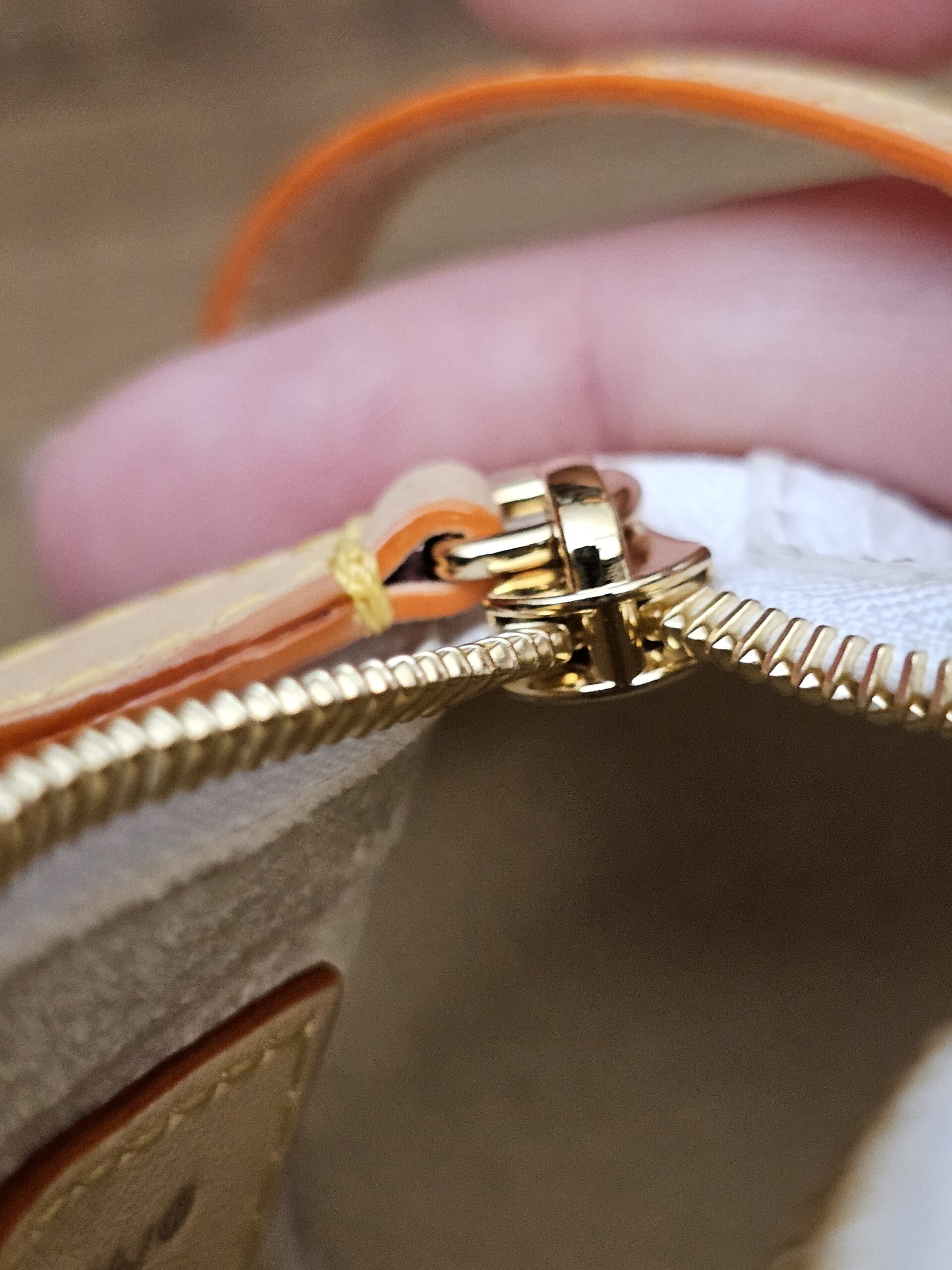 Close up of the gold-tone zip pull