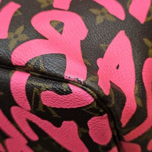 Close up of a base corner showing wear to the pink print