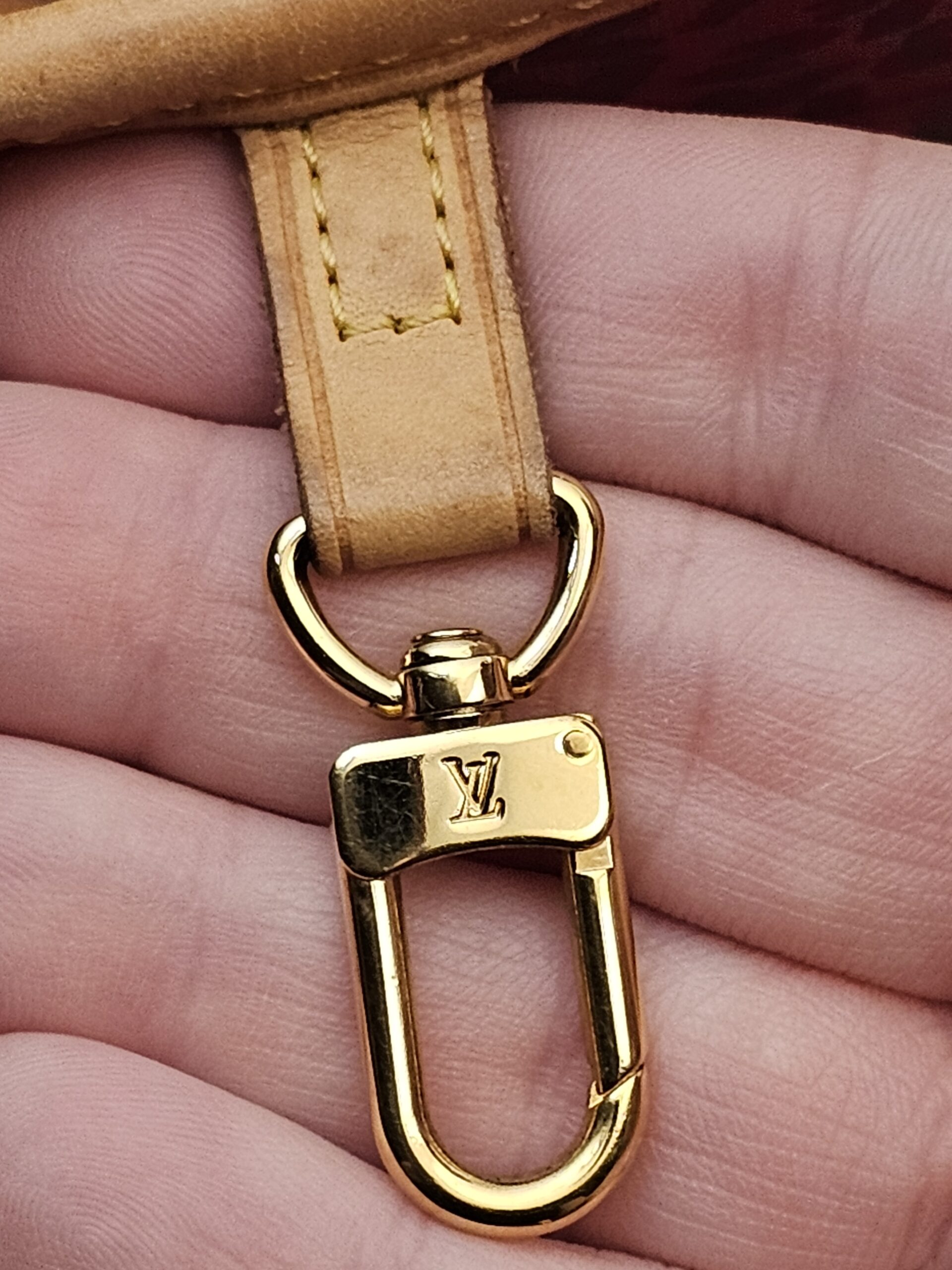 Gold-tone clasp on the interior key strap