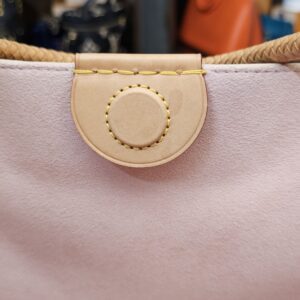 Vachetta tab and pink lining at the top opening