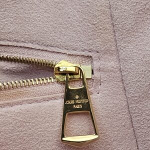 Gold-tone zip pull on the interior pocket