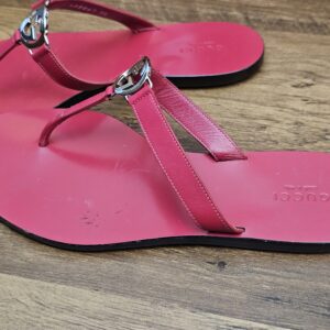 Pair from the side showing the toe posts and silver-tone logo buckles