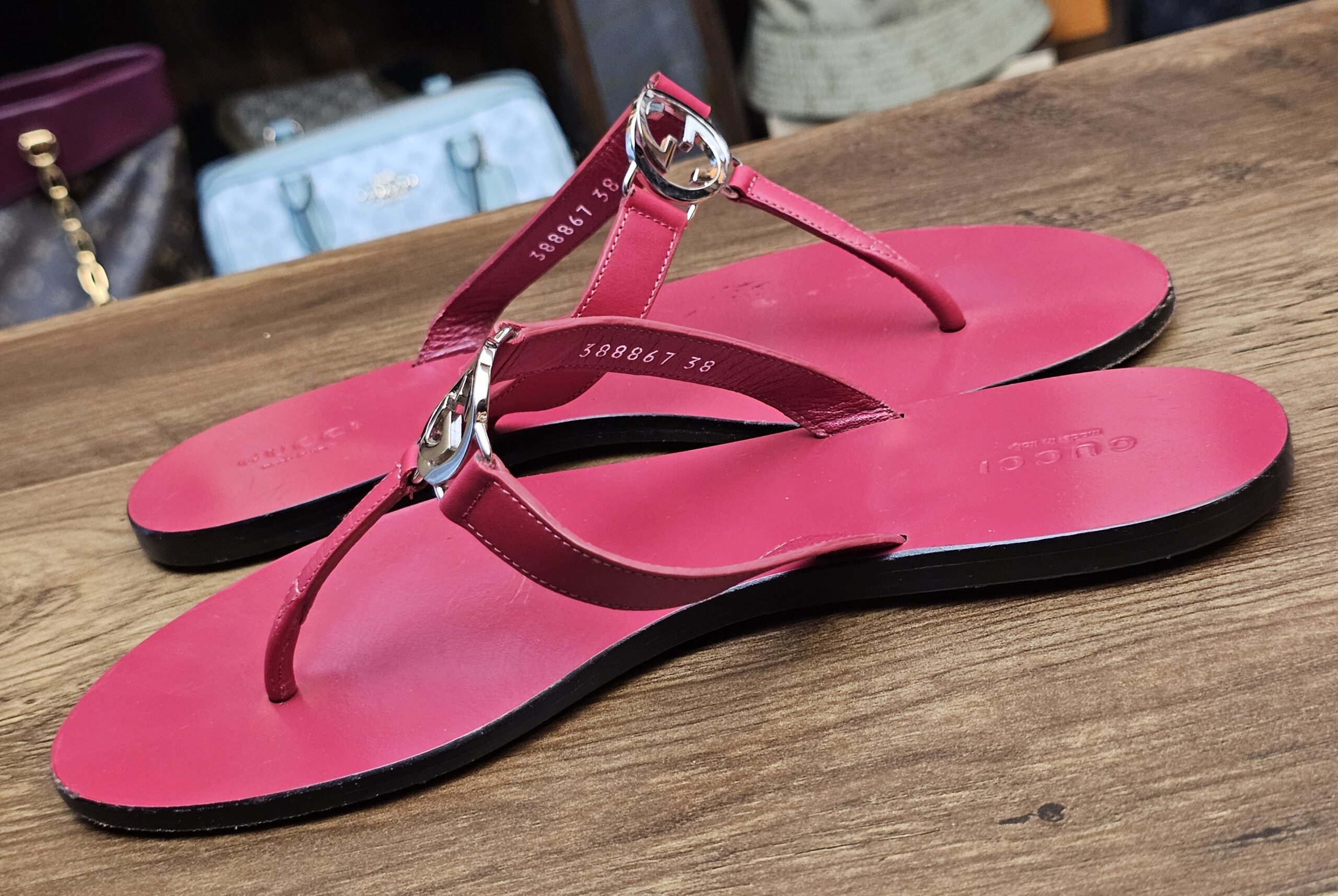 Pair at an angle showing the insole stamp and berry leather straps