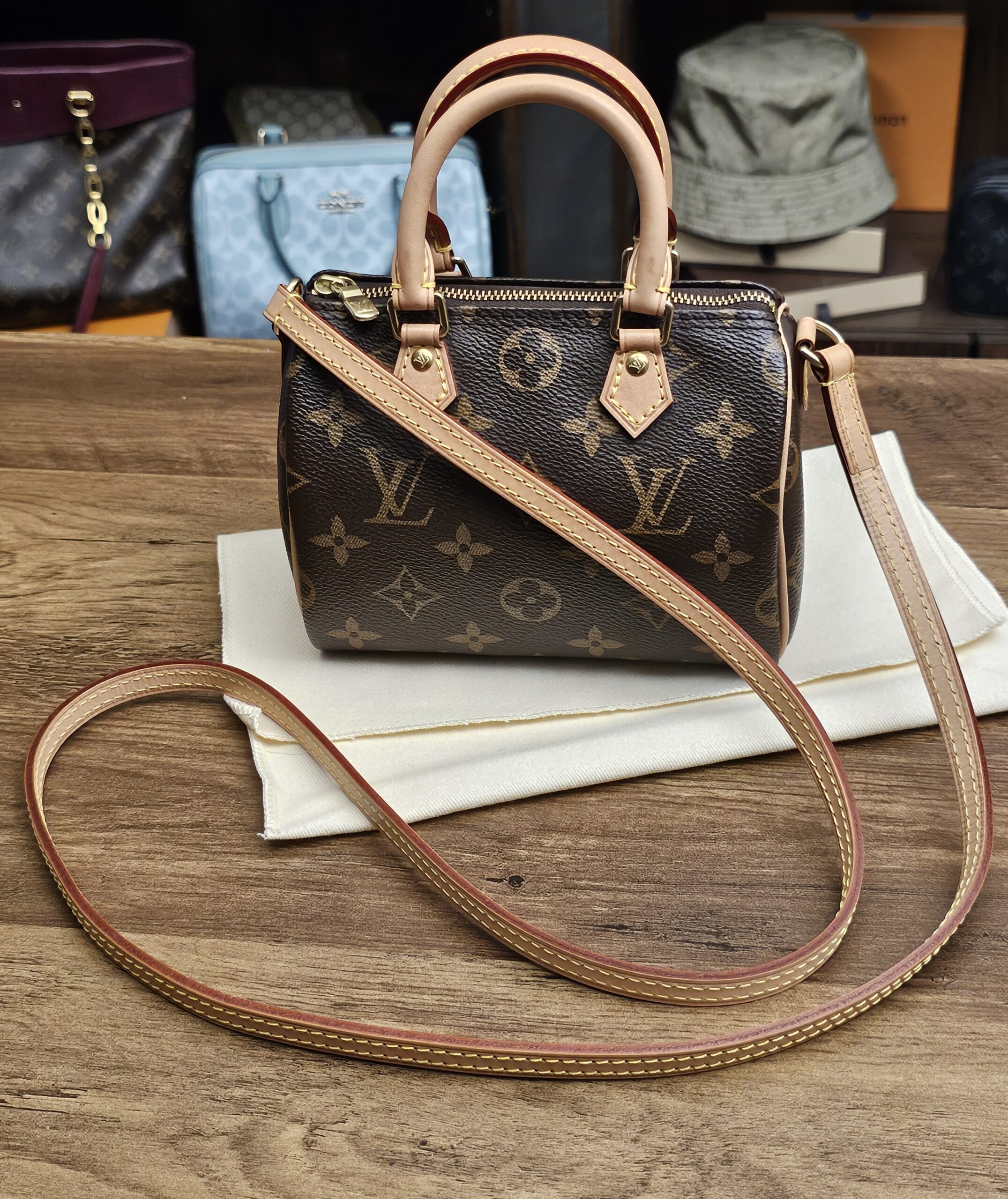 Louis Vuitton Monogram Nano Speedy - front view with the long vachetta shoulder strap