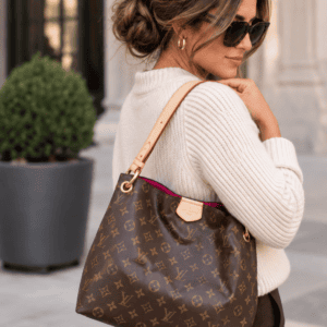 Styling image of a model carrying a Monogram Graceful, made by The Luxe Addiction