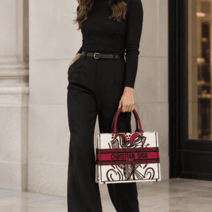 Illustrative model shot showing a Christian Dior Book Tote carried. This is a styling reference, not a photo of the item for sale