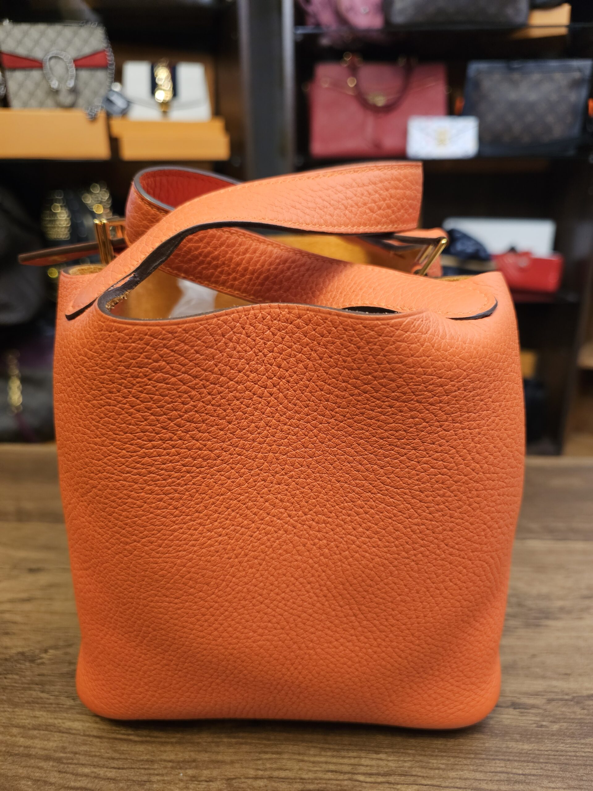 Other side of the bucket bag in orange grained leather